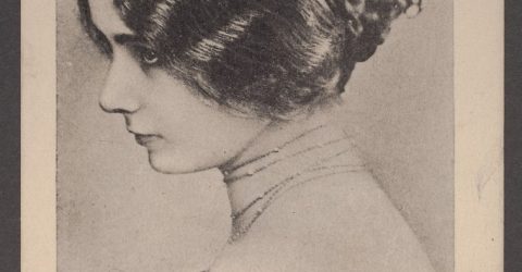 The image is a black-and-white portrait of a woman with wavy hair styled in a braided bun, viewed in profile. She is wearing an off-the-shoulder garment and appears elegant and composed. The bottom of the image contains a signature that reads “Cléo de Mérode.”